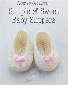 a pair of baby slippers with pink bows on the front and bottom, in crochet