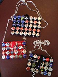 two pieces of beer bottle caps on a table with chains hanging from it's sides