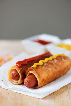 a hot dog with mustard and ketchup on a napkin