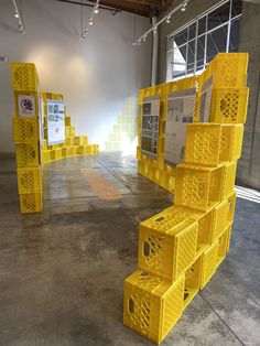 yellow crates stacked on top of each other in an empty room