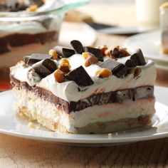 a piece of cake sitting on top of a white plate next to a glass dish