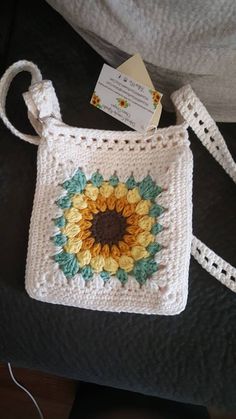 a crocheted bag with a sunflower on it