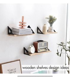 three wooden shelves on the wall with books and other items sitting on top of them