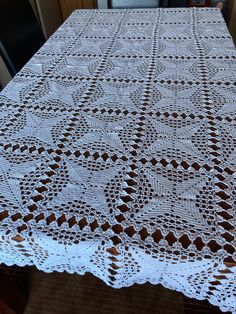 the table cloth is made with white crochet