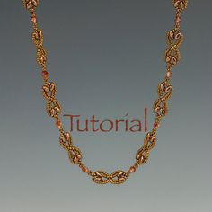 a gold necklace with pink beads and the word'tutor'written in red on it