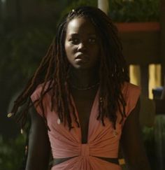 a woman with dreadlocks in an orange dress