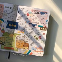 an open notebook with stickers on it