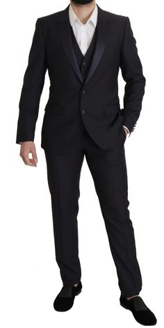 Step into the world of high fashion with this impeccably tailored black three-piece suit by Dolce & Gabbana. Exuding sophistication and a sharp modern silhouette, this suit features a sleek single-breasted blazer paired with matching trousers and a classic waistcoat. Crafted from a luxurious blend of virgin wool, silk, and polyester, it offers both comfort and style. The slim-fit design highlights a two-button blazer closure, notched lapels, and a concealed three-way zipper on the trousers, ensu Black Three Piece Suit, Slim Fit Suit, Three Piece Suit, 3 Piece Suits, Fashion Website, Blazer Buttons, Dolce & Gabbana, Three Piece, Mens Suits