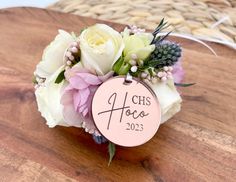 a bouquet of flowers sitting on top of a wooden table