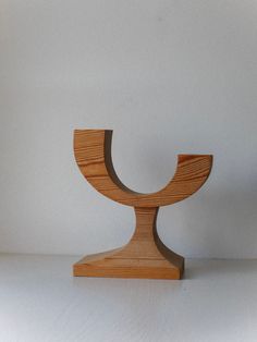 a wooden object sitting on top of a white table