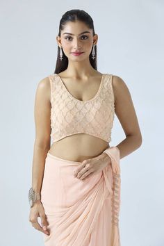 Peach plum ruffle pre-draped saree with pearl embroidery detailing on border and pallu. Paired with a matching blouse with geometric motif pearl embroidery. - Aza Fashions Sleeveless Pink Blouse For Reception, Sleeveless Ruffled Blouse For Wedding, Fitted Sleeveless Georgette Blouse Piece, Fitted Sleeveless Blouse Piece In Georgette, Sleeveless Pre-draped Saree With Ruffles For Reception, Fitted Sleeveless Georgette Blouse, Sleeveless Georgette Tops For Reception, Pink Sleeveless Georgette Blouse Piece, Elegant Sleeveless Georgette Pre-draped Saree