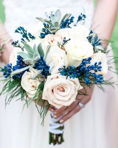 a bridal holding a bouquet of white and blue flowers