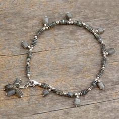 Labradorite anklet - Intuitive | NOVICA Labradorite Beaded Jewelry As A Gift, Silver Adjustable Spiritual Anklets, Silver Spiritual Anklets As Gift, Gift Labradorite Jewelry With Polished Beads, Gray Spiritual Jewelry With Gemstone Beads, Spiritual Gray Bracelet Jewelry, Silver Labradorite Gemstone Bead Bracelets, Silver Labradorite Bracelets With Gemstone Beads, Silver Labradorite Bracelets With Round Beads