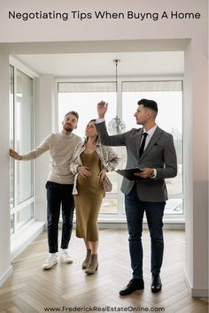 two men and a woman standing in front of a window with their hands up to the ceiling