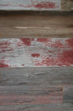 an old wooden wall with red paint on it's side and the bottom half painted white