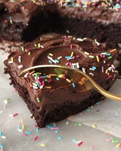 a chocolate cake with sprinkles and a spoon