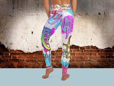 Add a splash of urban style to your workout wardrobe with these Graffiti Yoga Leggings! These high-waisted leggings are perfect for yoga, gym sessions, or casual wear. Featuring vibrant graffiti-inspired designs, they're crafted from 82% polyester and 18% spandex with a soft, luxurious peach skin finish. Designed with 4-way stretch fabric, they ensure maximum comfort and flexibility, allowing you to move freely during your activities. Features: Moisture-Wicking: Stay dry and comfortable with quick-drying fabric that absorbs moisture. Eco-Friendly: Crafted with care for the environment, perfect for the eco-conscious shopper. Tear-Away Care Label: Enjoy extra comfort with a removable care label. High-Waisted Fit: Flattering and supportive, these leggings stay in place no matter how intense y Stretch Multicolor Bottoms For Streetwear, Stretch Multicolor Activewear For Streetwear, Multicolor Stretch Bottoms For Streetwear, Multicolor Stretch Activewear For Streetwear, Fitted Graphic Print Leggings For Streetwear, Trendy Multicolor Graffiti Print Bottoms, Casual Graphic Print Leggings For Streetwear, White Leggings For Streetwear, White Graffiti Print Bottoms For Streetwear