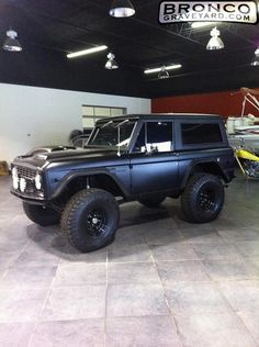 a black truck parked inside of a garage