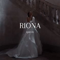 a woman in a wedding dress standing next to a staircase with the words riona written on it