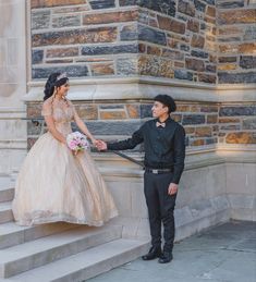 a bride and groom holding hands on the steps