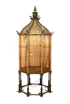 an antique birdcage with gold trimmings on the top and bottom part