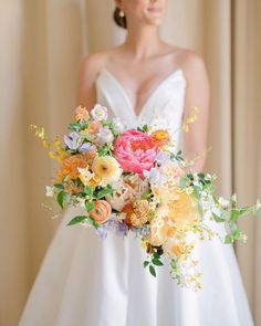 a bride holding a bouquet of flowers in her hand