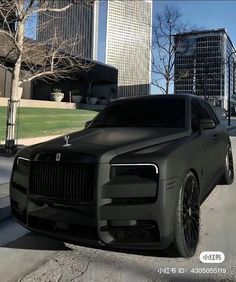 a black car parked on the side of a road in front of some tall buildings