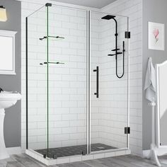 a white tiled bathroom with a walk in shower