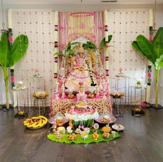 there is a statue in the middle of a table with cupcakes on it