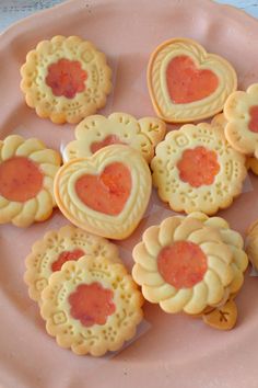 heart shaped cookies on a pink plate with hearts in the shape of flowers and hearts