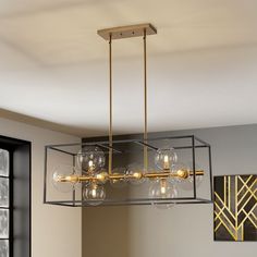 a chandelier hanging from the ceiling in a dining room with wine glasses on it