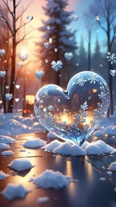 a heart - shaped glass sitting on top of snow covered ground