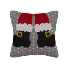 a knitted santa clause pillow on a white background