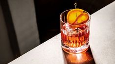 an orange slice sitting in a glass on top of a table