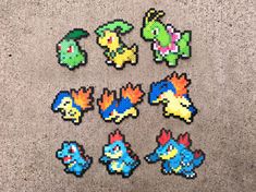 several pixelated pokemon stickers sitting on the ground