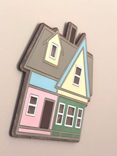 a house shaped magnet is hanging on the wall