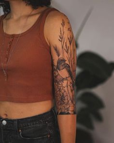 a woman with a bird tattoo on her left arm and right arm behind her back