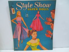 an old fashion paper doll book with people around it