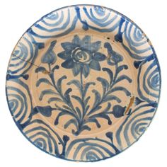 a blue and white plate with flowers on it