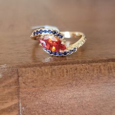 New! Orange And Blue Gems On A Gold Band By Fragrant Jewels Size 8 & 10 A1 Colorful Wedding Ring Stack, Fragrant Jewels, Orange Ring, Fantasy Ring, Orange Gem, Fancy Things, Blue Tanzanite, Orange Sapphire, Gem Ring