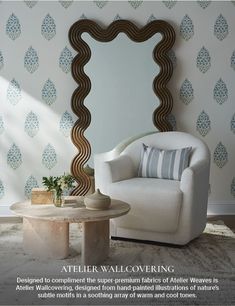 a white chair sitting in front of a mirror on top of a wall next to a table