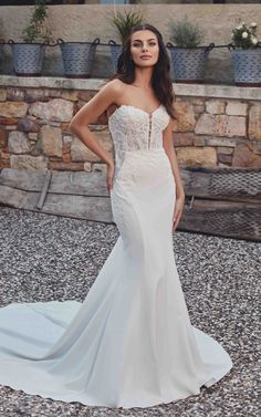 LYSETTE is a Fit-n-Flare crepe gown with beaded ivory lace, sequins and silver thread; Chantilly laces unlined bodice, skin cleavage, and buttons to the end of the train.