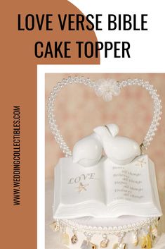 a cake topped with an open book and two doves on top of each other