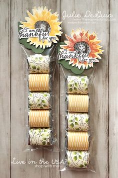 two packages of sunflowers are shown in front of a wooden background with the words thank you written on them