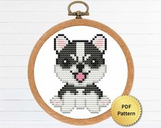 a cross stitch pattern with the image of a black and white dog in a bow tie