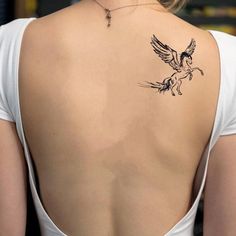 a woman with a tattoo on her back