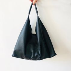 This bag has modern design and is really functional. It can be used as Vegan Leather plait Tote Bag, Leather Slouchy Bag, Hobo Bag, Shoulder Bag, Outside Bag, Large handbag, Shopping Bag for Women, Girl. This tote bag is extremely light, the leather is ultra soft. The bag can be used for work, school, shopping, holiday and traveling, and can put all your needs in daily life. Premium Quality vegan Leather Tote Bag which is Environmentally friendly materials. Size: 19.68 inch (50cm) on the top wid Modern Hobo Pouch Bag For Everyday Use, Modern Leather Softback Shoulder Bag, Modern Pouch Hobo Bag For Everyday Use, Modern Bags With Adjustable Strap And Softback, Modern Shoulder Bag With Adjustable Strap, Everyday Minimalist Shoulder Bag With Large Capacity, Minimalist Daily Shoulder Bag With Large Capacity, Daily Use Soft Leather Softback Bag, Everyday Modern Rectangular Hobo Bag