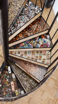 an overhead view of a spiral staircase with lots of different colored tiles on the floor