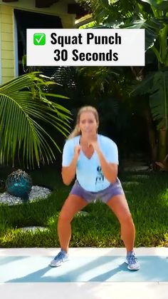 a woman standing in front of a house with her hands on her chest and the words squat punch 30 seconds above her head