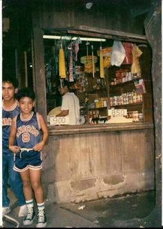 two young men standing in front of a store